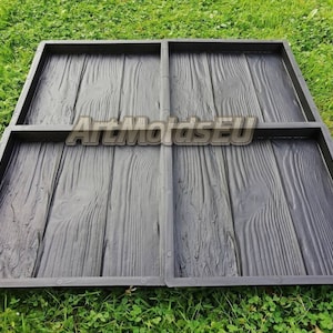 May include: A black plastic mold for making concrete patio stones. The mold has a wood plank design.