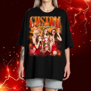 May include: Black t-shirt featuring a graphic of five women in red swimsuits holding lollipops. The text "CUSTOM Name" is printed in orange and yellow on the shirt.