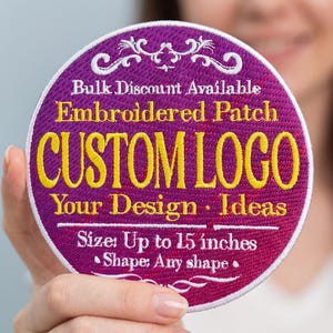 May include: A circular embroidered patch with a magenta background and yellow text that reads CUSTOM LOGO, Bulk Discount Available, Your Design Ideas, Size: Up to 15 inches, and Shape: Any shape, featuring white decorative flourishes and a white border.