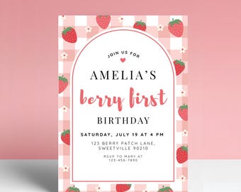 May include: A pink and white invitation card with a strawberry theme. The card features the text "Amelia's berry first birthday" and event details. Strawberries and small white flowers decorate the border.