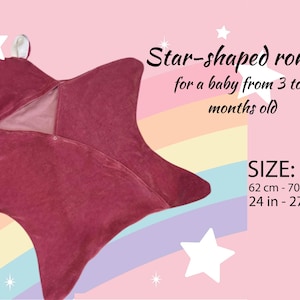 May include: A star-shaped pink romper for a baby, with a zipper closure. The romper is sized for a baby from 3 to 6 months old. Size: 62 cm - 70 cm, 24 in - 27 in.
