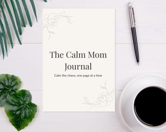 May include: A journal titled "The Calm Mom Journal" with the tagline "Calm the chaos, one page at a time." The journal is on a white wooden surface, next to a pen and a cup of coffee. Decorative floral elements are in the corners.