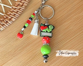 Handmade, unique, book worm teacher keychain! Lobster clasp, metal bar, 20” acrylic bead, beaded tassel with apple charm pendant!