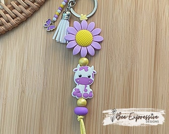 Beaded Cow Keychain: Purple Sunflower, Butterfly Charm, Tassel