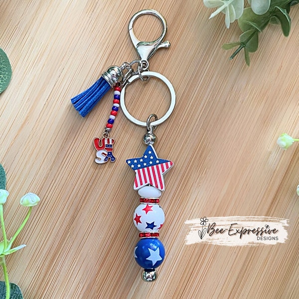 Handmade, unique, Americana keychain! Lobster claw, wood beads with stars, silicone pinwheel, rhinestone spacers, beaded tassel with charm!