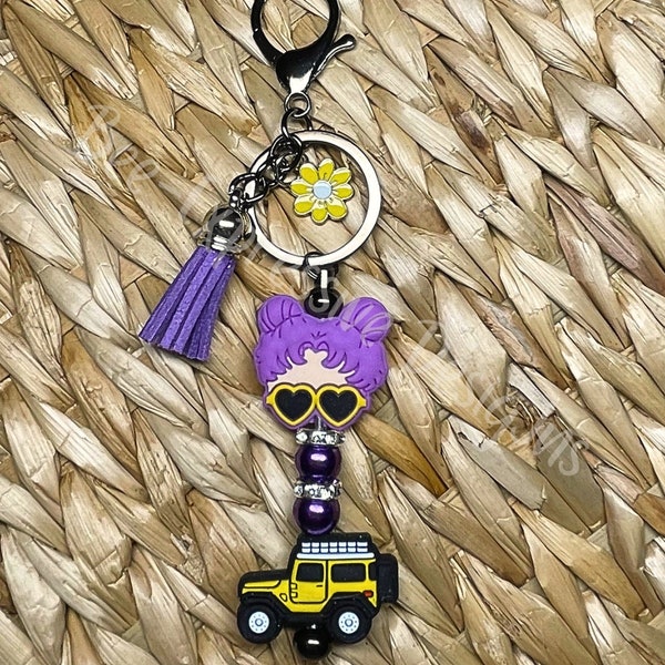 Adorable, handmade, yellow atv off-road keychain & purple haired girl! Lobster claw clasp, interchangeable keychain, and yellow daisy charm!