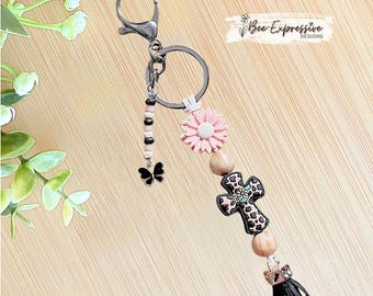 Handmade, Decorative Black Cross, Keychain: Daisy, Suede Cord, Wood Beads & Butterfly Tassel