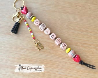 Handmade Chiefs Football Beaded Keychain: beaded tassel with custom jersey # charm, square wood beads.