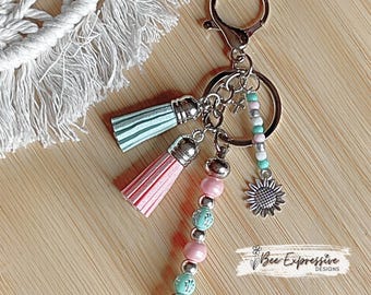 Handmade Beaded Keychain: Cross Inlay, Sunflower Charm, Suede Tassels