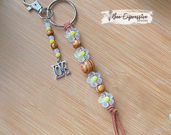 Handmade, acrylic flower, wood beaded keychain! Swivel clasp, suede cord, daisy flower beads, beaded tassel with a LOVE charm!