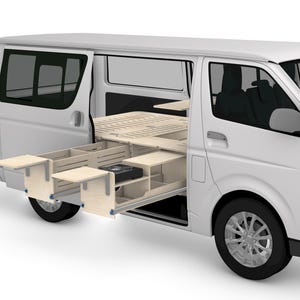 May include: A white van with an open side showing a custom wooden interior. The interior includes a bed frame, drawers, and a small appliance. The van's wheels are visible, and the windows are tinted.