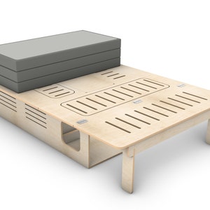 May include: A wooden platform bed frame with a gray mattress on top. The frame has a slatted design and a cutout for storage.