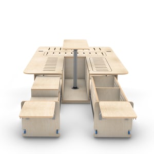 May include: A wooden table with a removable top and two pull-out drawers on wheels. The table has a central support pole and a small table top that can be raised and lowered.