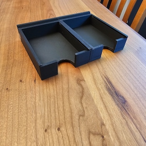 May include: Two black plastic card holders with a cutout for easy access to cards. The holders are on a wooden surface.