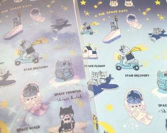 May include: A sheet of stickers featuring illustrations of cats in space. The stickers are on a blue background with stars and the text "The Space Cats" and "Space Tourism Shinzi Katoh".