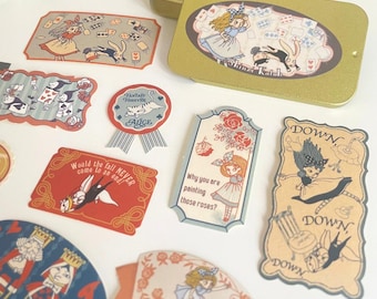May include: A set of vintage-style Alice in Wonderland themed stickers featuring illustrations of Alice, the White Rabbit, the Queen of Hearts, and other characters. The stickers are printed on a variety of paper textures and feature a whimsical, fairytale aesthetic.