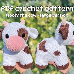 May include: PDF crochet pattern for a large version of a white and brown crocheted cow. The cow has a pink nose and brown eyes.