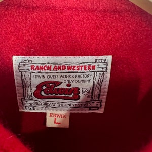 May include: Red denim jacket with a brown leather label that reads "RANCH AND WESTERN EDWIN OVER WORKS FACTORY ONLY GENUINE" and a white label that reads "EDWIN".
