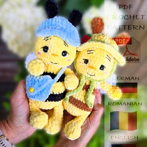 May include: Two plush yellow bee toys with black stripes, blue hats, and small wings. One bee has a blue satchel. The toys are handmade and appear soft. The image also includes text that says "PDF Crochet Pattern".