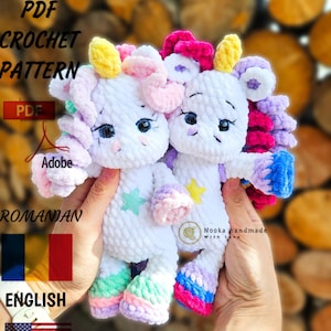 May include: Two white crocheted unicorn amigurumi toys with colorful details. The unicorn on the left has a yellow horn, pink mane, and light green and purple legs. The unicorn on the right has a pink horn, pink mane, and pink and blue legs. Both unicorns have black eyes and a white star on their bodies. The text "Nooka handmade with love" is visible on the image.