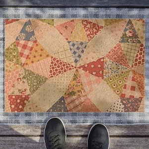 May include: A patchwork doormat with a variety of colorful fabrics in a geometric pattern. The doormat has a white border with a checkered pattern.