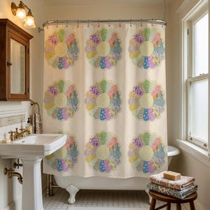 May include: A shower curtain featuring a repeating pattern of large, circular floral motifs. Each flower is composed of multiple colorful, patterned fabric-like petals in shades of pink, blue, yellow, and green, set against a cream background.