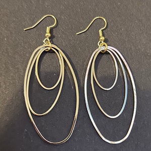 Dangle Earrings In Silver and Gold Tone.