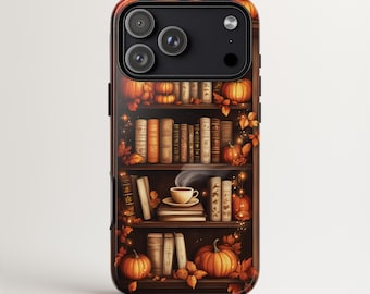 May include: A phone case featuring a bookshelf design with pumpkins, books, and autumn leaves. The case has a dark brown wood-like background and the text "iPhone MagSafe | Samsung Galaxy S | Google Pixel".