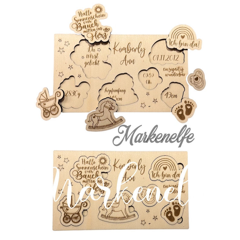 May include: Wooden baby announcement puzzle with a rocking horse, a baby carriage, footprints, and a cloud with the text "Kimberly Ann" and "Ich bin da!" (I am here!). The puzzle pieces are cut out and ready to be assembled. The puzzle is made of light brown wood and has a natural finish.