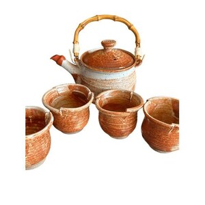 May include: A ceramic tea set featuring a teapot with a bamboo handle and lid, and four matching cups. The teapot and cups have a speckled, earthy brown and white glaze. The teapot's spout is red.