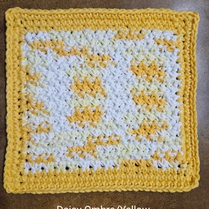May include: A crocheted dishcloth in shades of yellow and white with a daisy ombre pattern. The dishcloth measures 7 1/2 to 8 inches.