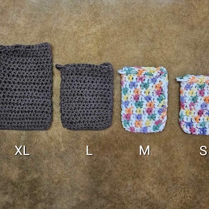 May include: Four crocheted soap sacks in different sizes: XL, L, M, and S. The XL and L sacks are brown, while the M and S sacks are multicolored with a white background.