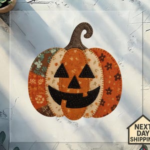 May include: A handmade, patchwork pumpkin decoration with a smiling jack-o'-lantern face. The pumpkin features orange, brown, and cream-colored fabrics with floral patterns. The stem is a dark brown color. Perfect for Halloween.