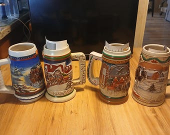 1996,1997,1998,and 2002 Budweiser Holiday Steins with original box and Certificate of Authenticity.