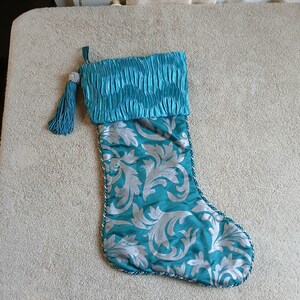 Vintage Christmas Stocking with Roped Trim and A Beautiful Tessil and Silver Ball. Silk Material on inside.