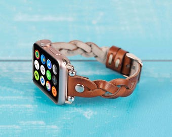 May include: A braided brown leather watch strap with a white leather accent. The strap is designed for an Apple Watch and has a rose gold finish.