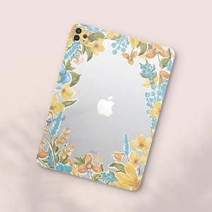 May include: Clear iPad case with a floral design. The case features a border of yellow, blue, and orange flowers and green leaves. The Apple logo is visible on the back of the iPad. The word "iPad" is printed at the bottom.