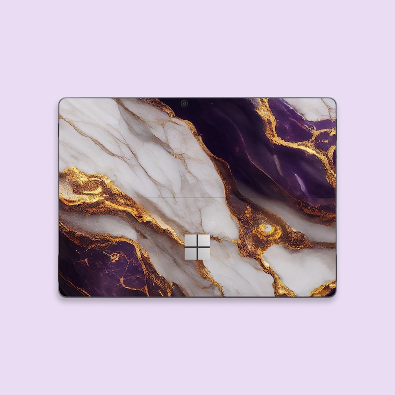 a purple and gold marbled surface with a white square in the middle