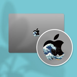 an image of an apple sticker on a laptop