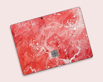 May include: Red and white marble-patterned laptop skin with a black Microsoft logo.