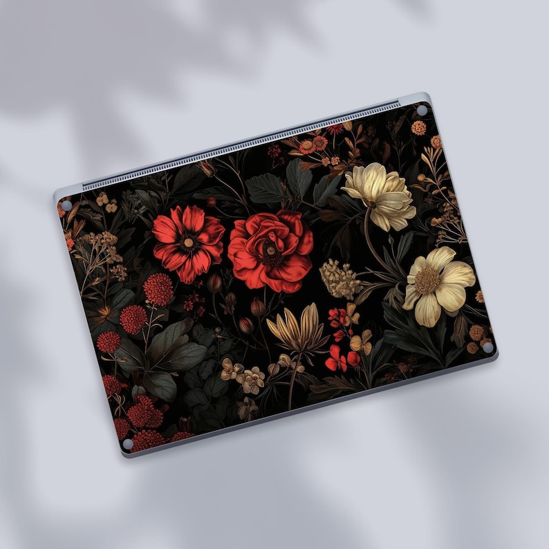 a picture of a laptop with flowers on it