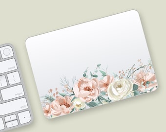 May include: A rectangular mousepad with a floral design. The design features watercolor-style flowers in shades of peach, white, and green. The flowers are arranged along the bottom edge of the mousepad against a white background. A computer keyboard is visible in the corner.