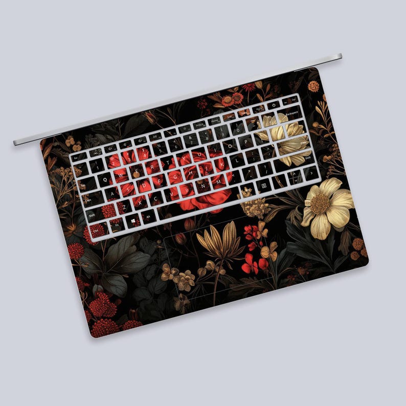 a computer keyboard with a floral design on it