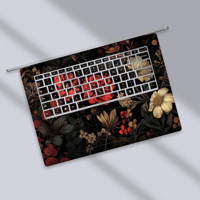 a close up of a keyboard with flowers on it