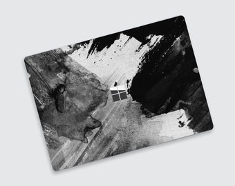 May include: Black and white abstract paint splatter design laptop skin. The design features large black brushstrokes on a white background.