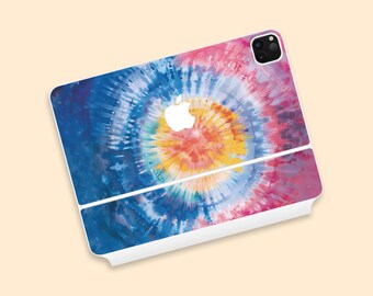 May include: An Apple iPad Pro with a colorful tie-dye skin. The design features a spiral pattern with shades of blue, pink, yellow, and orange. The Apple logo is visible in white. The iPad is white.