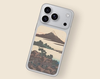 May include: A silver iPhone case featuring a Japanese landscape design. The artwork depicts a mountain, water, and traditional houses. The case has a smooth finish and a camera module with three lenses.