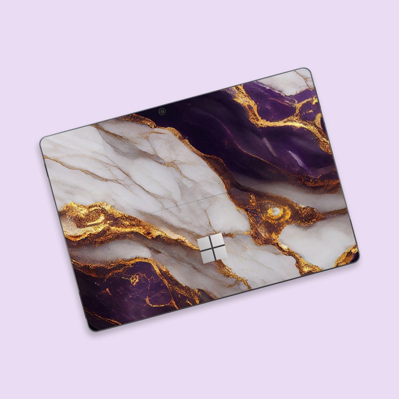 a computer mouse pad with a purple and gold marble design