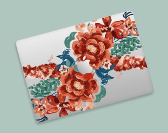 May include: A laptop with a floral design. The design features large, watercolor-style flowers in shades of red, orange, and peach, with green and blue foliage. The laptop has a silver finish and the Apple logo is visible.