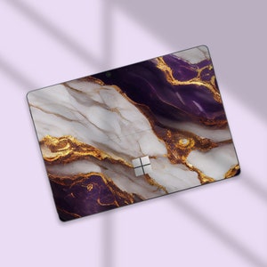 a computer mouse pad with a purple and gold design